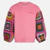 Maglia da bambina rosa con maniche all'uncinetto