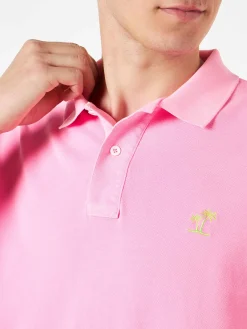Polo in piquet rosa con logo St. Barth ed effetto vintage